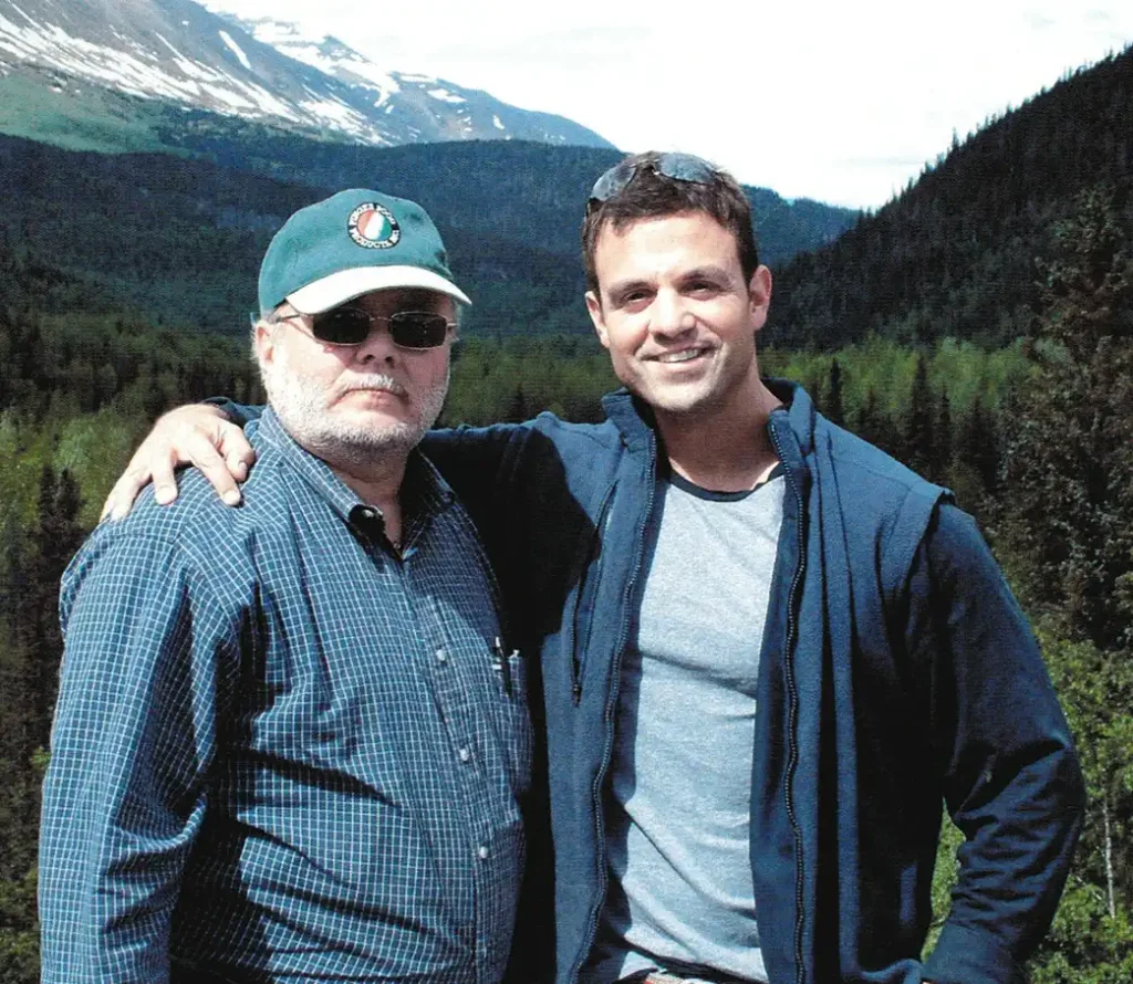 Former President Robert Cordova (left) with son, Former President Jason Cordova (right) in front of mountainside.